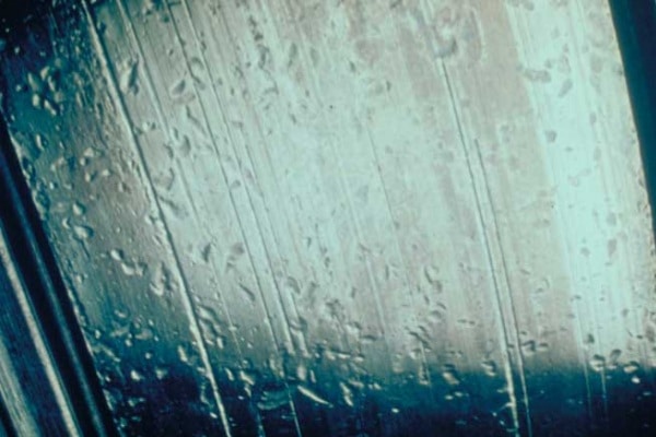 Bearing raceway showing pitting and scratches caused by dirt and particle contamination.