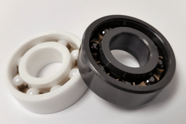 A high-precision full ceramic bearing made from silicon nitride (Si3N4), showing ceramic rings and balls for high-speed applications.