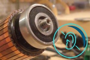 A maintenance technician using a stethoscope to listen to motor bearing noise in an industrial setting.