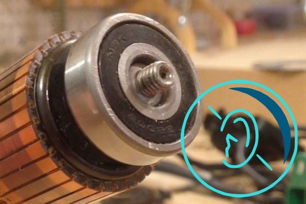 A maintenance technician using a stethoscope to listen to motor bearing noise in an industrial setting.